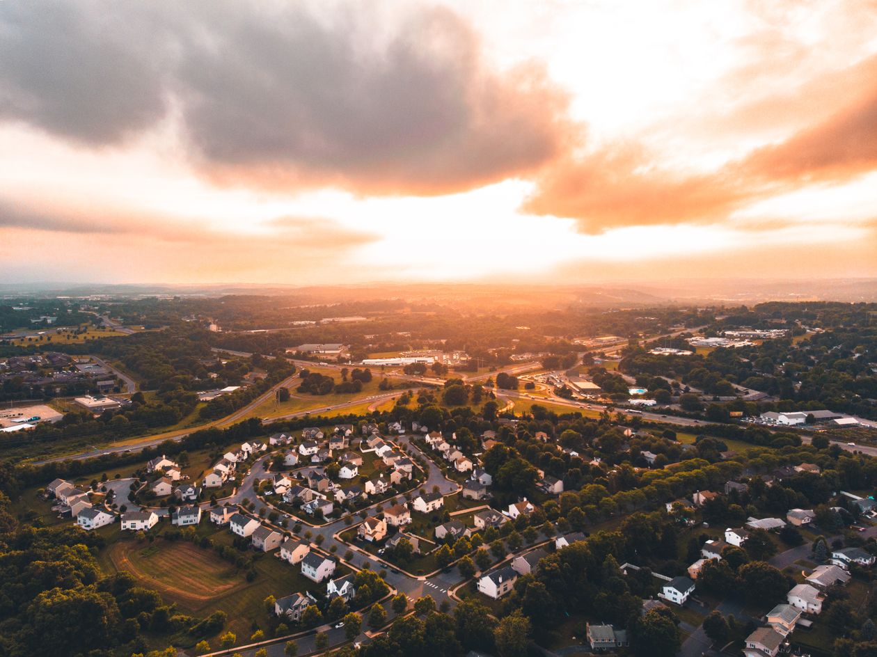 Aerial view of Raleigh NC neighborhood rooftops at sunset